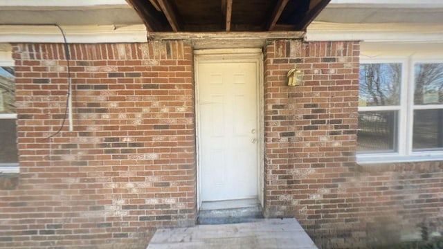 entrance to property with brick siding