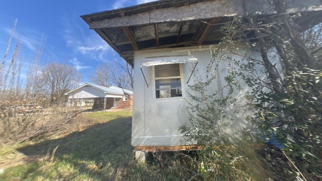 view of side of property featuring stucco siding