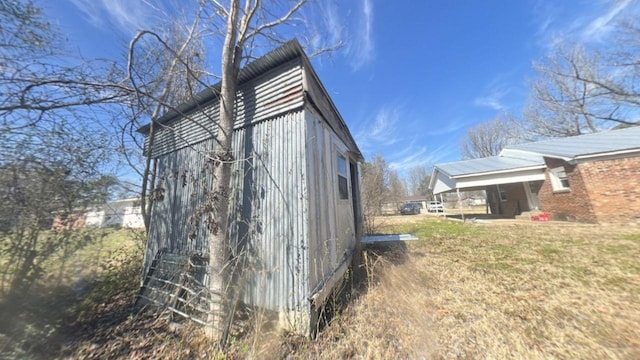 view of side of property featuring a yard and brick siding