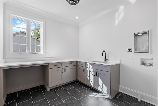 clothes washing area with baseboards, ornamental molding, hookup for an electric dryer, washer hookup, and a sink