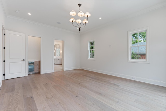 unfurnished bedroom featuring multiple windows, crown molding, and light wood finished floors