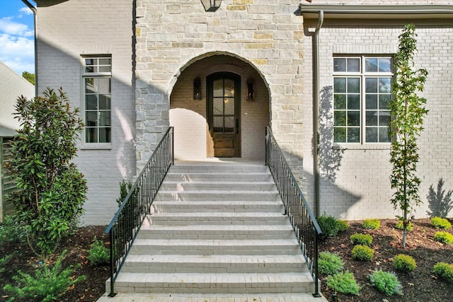 entrance to property featuring brick siding