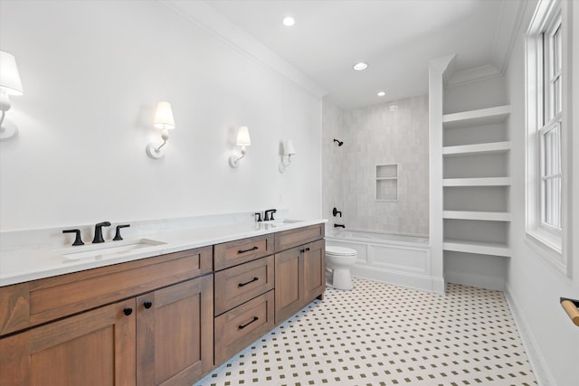 full bathroom featuring toilet, crown molding, a sink, and bathing tub / shower combination