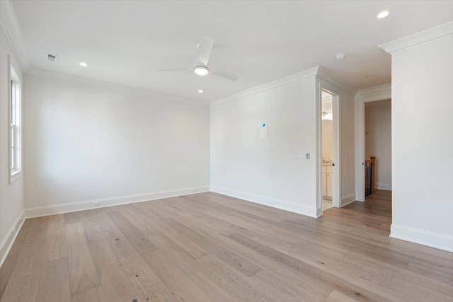 unfurnished room featuring ornamental molding, light wood-type flooring, and visible vents