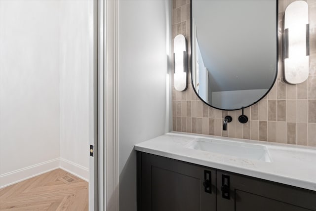 bathroom with vanity, tile walls, and baseboards