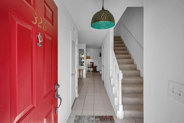 foyer with stairs and light tile patterned floors