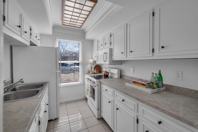 kitchen with light tile patterned floors, white appliances, a sink, and white cabinetry