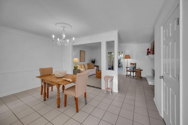 dining space featuring a chandelier, ornamental molding, baseboards, and light tile patterned floors