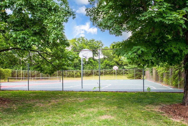 view of basketball court featuring community basketball court, a lawn, a tennis court, and fence