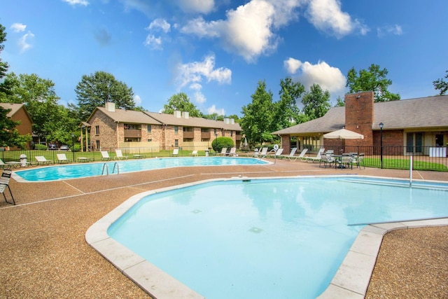 pool featuring a patio area and fence