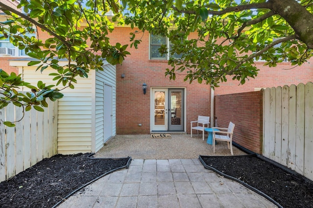 doorway to property with french doors, a patio area, and fence