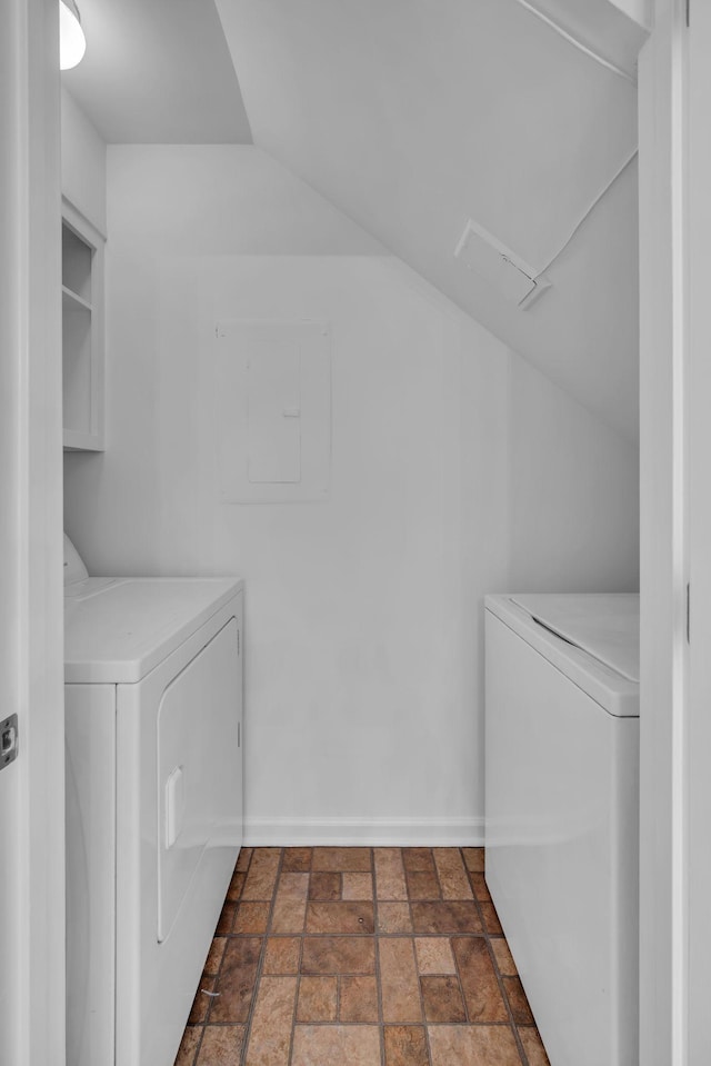 laundry room featuring laundry area, electric panel, baseboards, and independent washer and dryer
