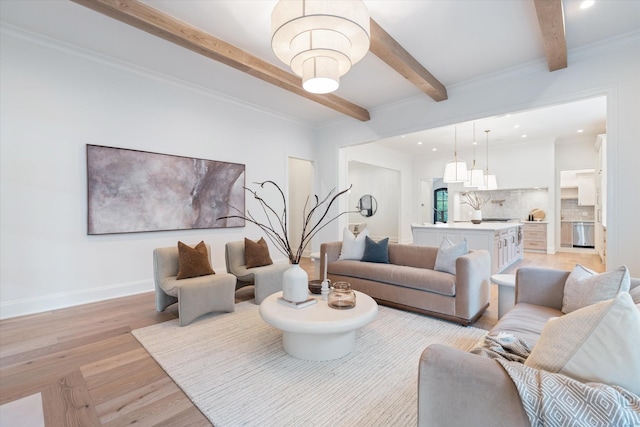 living area with beamed ceiling, recessed lighting, light wood-style flooring, and baseboards