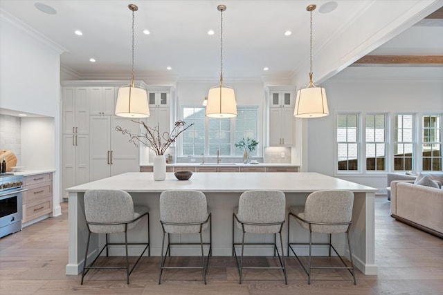 kitchen featuring tasteful backsplash, glass insert cabinets, and a wealth of natural light