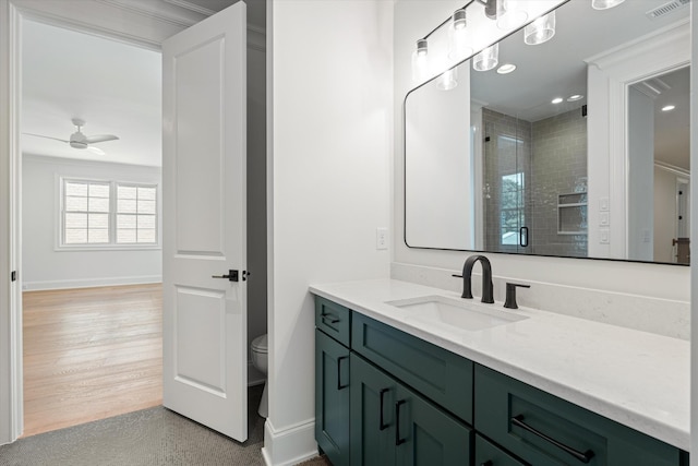 full bath featuring baseboards, visible vents, a ceiling fan, toilet, and a shower stall