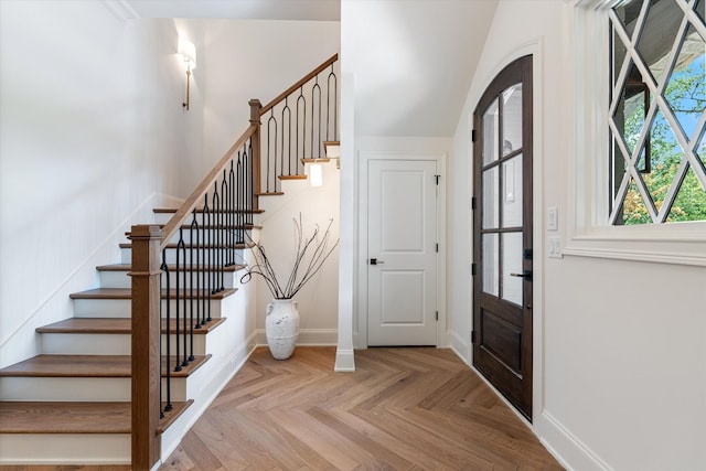 foyer with stairs and baseboards