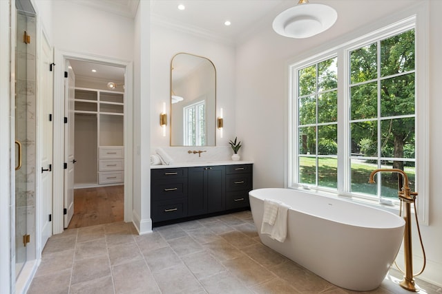 full bath featuring ornamental molding, a stall shower, plenty of natural light, and vanity