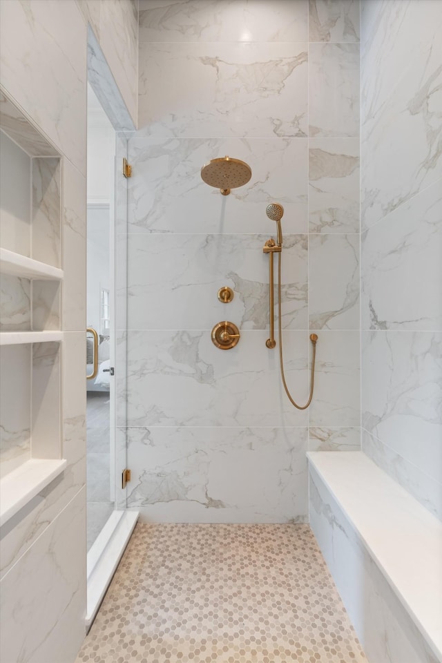 bathroom with a marble finish shower