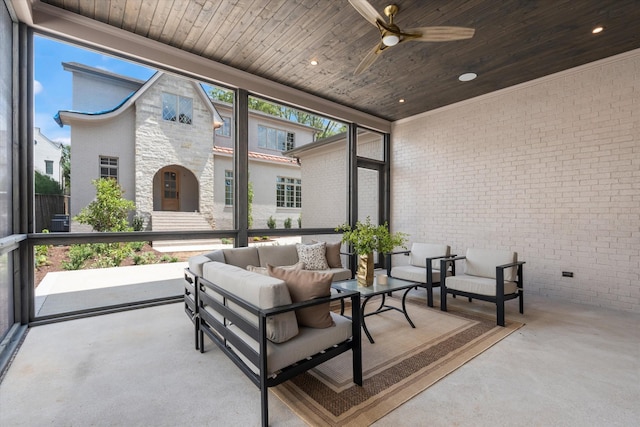 sunroom / solarium with a ceiling fan, a wealth of natural light, and wooden ceiling