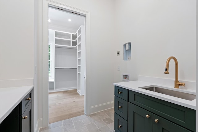 bathroom featuring baseboards and vanity