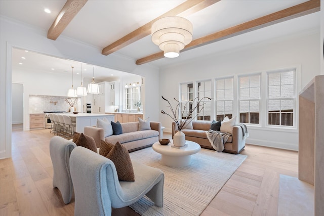 living area featuring baseboards, beamed ceiling, light wood-style flooring, and recessed lighting