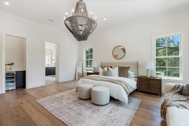 bedroom with ornamental molding, beverage cooler, multiple windows, and light wood-style floors