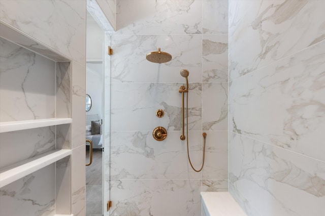 bathroom with a marble finish shower