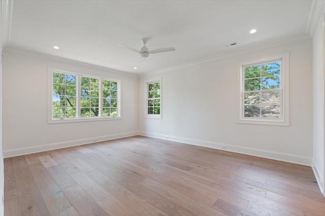 spare room featuring baseboards, ceiling fan, light wood-style floors, and crown molding