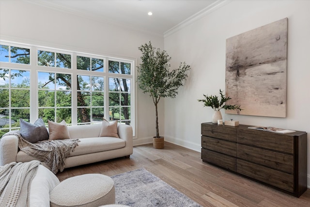 living area with ornamental molding, recessed lighting, baseboards, and wood finished floors