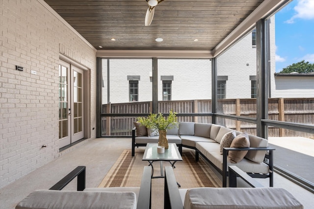 sunroom featuring a ceiling fan and wooden ceiling