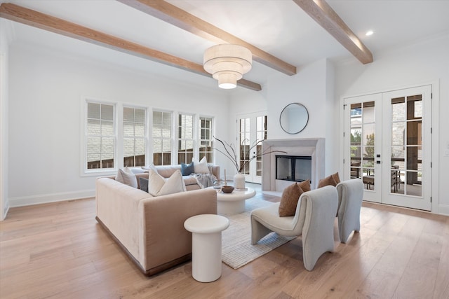 living room featuring light wood-style floors, french doors, beamed ceiling, and baseboards