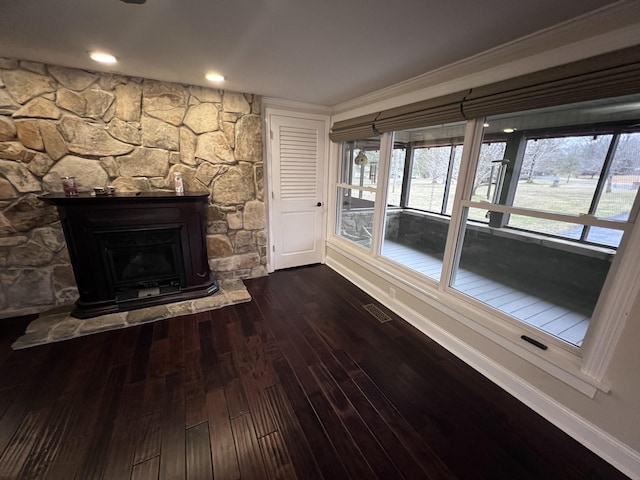 unfurnished living room with recessed lighting, a fireplace, wood finished floors, visible vents, and baseboards