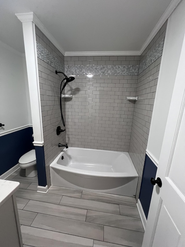 full bath featuring vanity, bathtub / shower combination, toilet, and crown molding