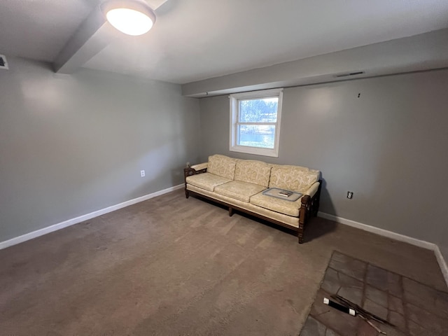 unfurnished living room with carpet floors, visible vents, and baseboards