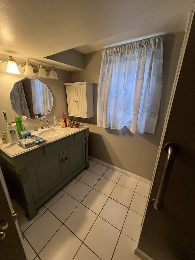 bathroom with tile patterned flooring, vanity, and baseboards