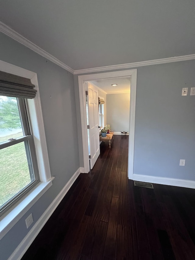 corridor with baseboards, dark wood-style floors, and crown molding