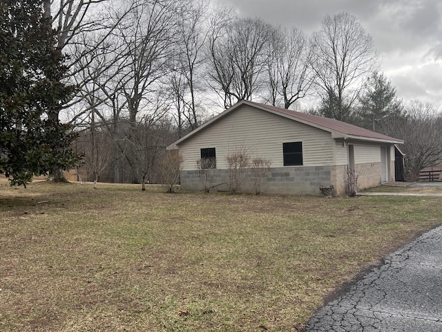 view of home's exterior with a garage and a yard