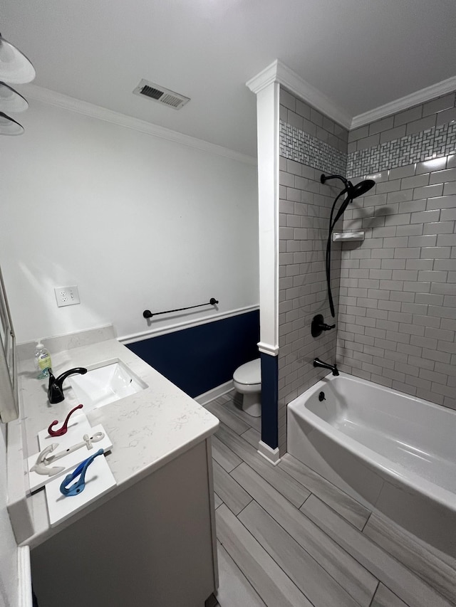 bathroom featuring toilet, vanity, visible vents,  shower combination, and crown molding