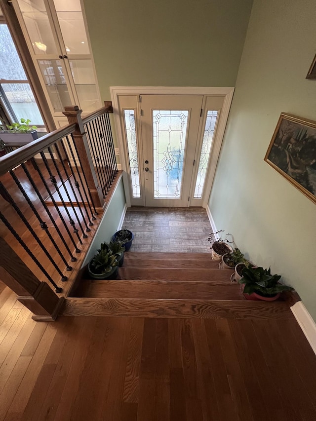 foyer with stairs, hardwood / wood-style floors, and a healthy amount of sunlight