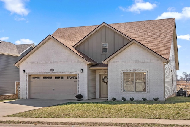 view of front of home with an attached garage, brick siding, concrete driveway, a front lawn, and board and batten siding