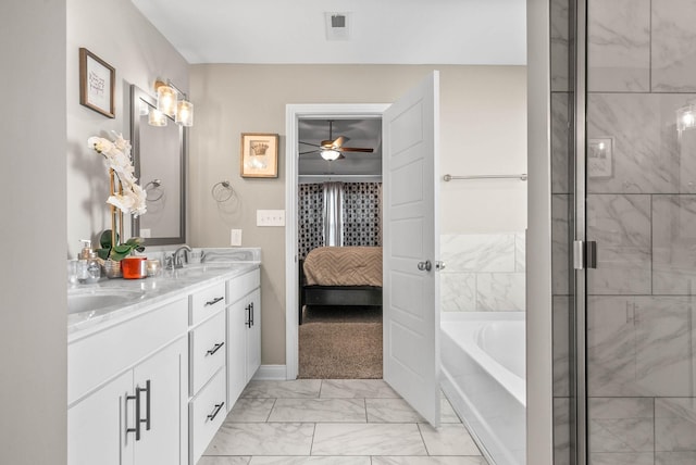 bathroom featuring ensuite bathroom, a garden tub, a sink, visible vents, and marble finish floor