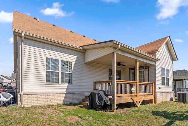 back of property featuring a ceiling fan, roof with shingles, and central AC unit