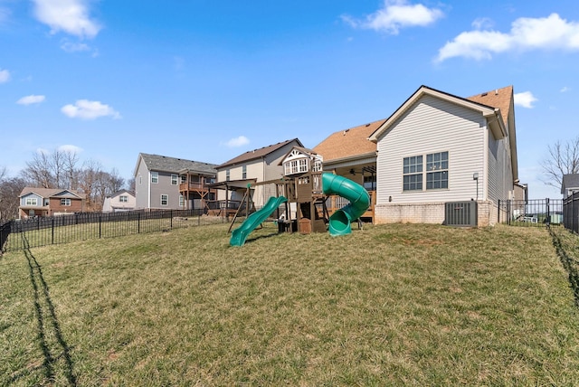 view of play area featuring a yard, central AC, and a fenced backyard