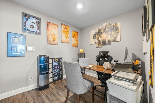 home office with baseboards and wood finished floors