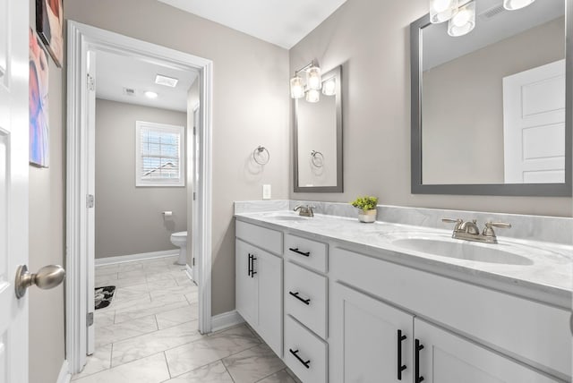 bathroom with marble finish floor, baseboards, a sink, and toilet