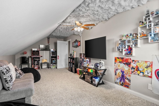 living room featuring a textured ceiling, a ceiling fan, baseboards, vaulted ceiling, and carpet