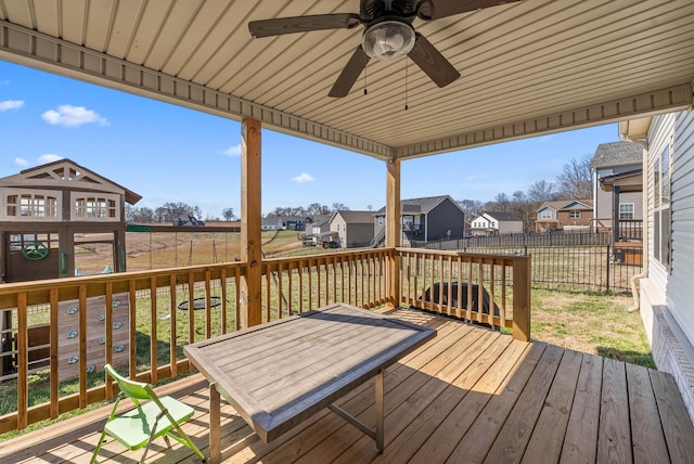 deck with a residential view, fence, and a ceiling fan