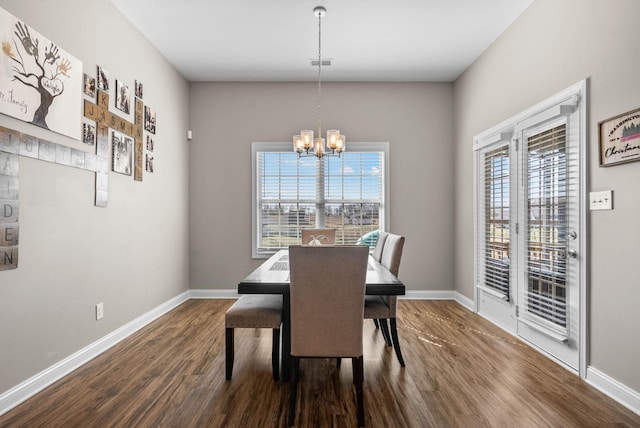 dining room with baseboards, dark wood finished floors, and a notable chandelier