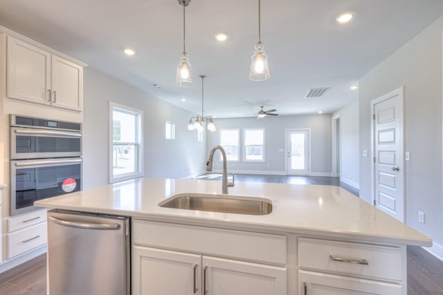 kitchen featuring appliances with stainless steel finishes, recessed lighting, open floor plan, and a sink