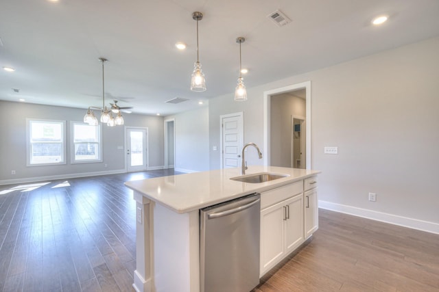 kitchen with visible vents, open floor plan, wood finished floors, stainless steel dishwasher, and a sink